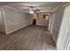 A spacious living room featuring modern flooring, gray walls and adjacent kitchen at 636 Raven Springs Trl, Stone Mountain, GA 30087