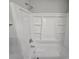 Clean white tub/shower combination with built-in shelving for bath products at 636 Raven Springs Trl, Stone Mountain, GA 30087