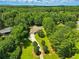 An aerial view showcases the property's lush landscaping, mature trees and long driveway at 1920 Daves Creek Trl, Cumming, GA 30041