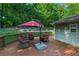 Inviting back deck featuring a seating area under a red umbrella, perfect for outdoor relaxation and entertaining at 1920 Daves Creek Trl, Cumming, GA 30041