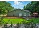 Large backyard with a wooden deck perfect for entertaining, surrounded by lush greenery at 1920 Daves Creek Trl, Cumming, GA 30041