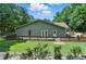 Expansive backyard with a spacious wooden deck, lush green lawn and mature trees at 1920 Daves Creek Trl, Cumming, GA 30041