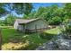 Backyard featuring well-maintained lawn, wood deck, and lush trees at 1920 Daves Creek Trl, Cumming, GA 30041