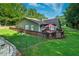 Spacious backyard featuring a deck with outdoor seating, a fenced yard, and mature trees at 1920 Daves Creek Trl, Cumming, GA 30041