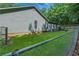 Fenced backyard featuring lush lawn, home's exterior, and a wooden deck at 1920 Daves Creek Trl, Cumming, GA 30041