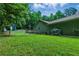 Expansive backyard with lush green grass, mature trees, and a fenced perimeter for privacy at 1920 Daves Creek Trl, Cumming, GA 30041