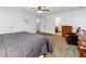 Carpeted bedroom with neutral colors, ceiling fan, ensuite bathroom, and dresser at 1920 Daves Creek Trl, Cumming, GA 30041