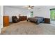 Carpeted bedroom featuring neutral colors, ceiling fan, and natural lighting at 1920 Daves Creek Trl, Cumming, GA 30041