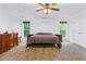 Carpeted bedroom featuring neutral colors, ceiling fan, and natural lighting at 1920 Daves Creek Trl, Cumming, GA 30041