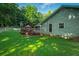 Exterior view of home featuring a large wooden deck, fenced yard, and well-manicured lawn at 1920 Daves Creek Trl, Cumming, GA 30041