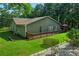 Exterior of home showcasing a spacious wooden deck, fenced yard, and mature landscaping at 1920 Daves Creek Trl, Cumming, GA 30041