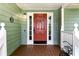 A charming red front door is surrounded by white trim and sidelights at 1920 Daves Creek Trl, Cumming, GA 30041