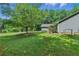 Charming home boasts a lush green lawn, mature trees, and a partially fenced yard at 1920 Daves Creek Trl, Cumming, GA 30041