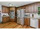 Kitchen featuring stainless steel appliances, granite countertops, and dark wood cabinets at 1920 Daves Creek Trl, Cumming, GA 30041