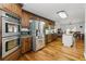 Kitchen featuring stainless steel appliances, granite countertops, dark wood cabinets, and a dining area at 1920 Daves Creek Trl, Cumming, GA 30041