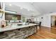 Open kitchen with granite countertops, stainless steel appliances, and a dining area at 1920 Daves Creek Trl, Cumming, GA 30041