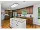 Kitchen featuring dark wood cabinets, granite countertops, stainless steel appliances, and a center island at 1920 Daves Creek Trl, Cumming, GA 30041