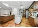Spacious kitchen with dark wood cabinets, granite countertops, stainless steel appliances, and hardwood floors at 1920 Daves Creek Trl, Cumming, GA 30041