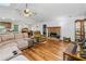Bright living room with brick fireplace, hardwood floors, and a vaulted ceiling at 1920 Daves Creek Trl, Cumming, GA 30041