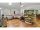 Open living space with wood floors, a large sofa, and an eat-in kitchen at 1920 Daves Creek Trl, Cumming, GA 30041