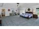 Spacious main bedroom with a tray ceiling, carpeted floors, a four-post bed, and French doors at 1920 Daves Creek Trl, Cumming, GA 30041