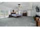 Large main bedroom with tray ceiling, carpet and barn doors into the en-suite bathroom at 1920 Daves Creek Trl, Cumming, GA 30041