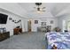 Spacious carpeted main bedroom with tray ceiling, fan, and plenty of natural light at 1920 Daves Creek Trl, Cumming, GA 30041