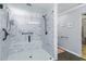 Accessible glass shower featuring grab bars, built-in seating, and a rain shower head at 1920 Daves Creek Trl, Cumming, GA 30041