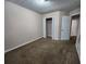Bedroom featuring carpet, neutral walls, closet and doors, offering a blank canvas for personalization at 2527 Plymouth Way, Conyers, GA 30013