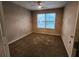 Bedroom with carpeted flooring and natural light, offering a neutral space ready for personal touches at 2527 Plymouth Way, Conyers, GA 30013