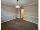 Comfortable dining area with classic trim, carpet floors, and a pendant light fixture at 2527 Plymouth Way, Conyers, GA 30013