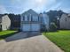 Charming two-story home with a well-maintained lawn and a two-car garage at 2527 Plymouth Way, Conyers, GA 30013