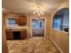 Cozy kitchen and dining area with traditional wood cabinets and chandelier at 2527 Plymouth Way, Conyers, GA 30013