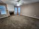 Expansive living room featuring plush carpet, a fireplace, and large windows for natural light at 2527 Plymouth Way, Conyers, GA 30013