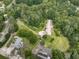 Aerial view of homes surrounded by mature trees, highlighting the property's privacy and the lush green landscape of the neighborhood at 2760 Hembree Ne Rd, Marietta, GA 30062