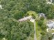 Aerial view of a sprawling home with a long driveway, set amidst lush greenery, mature trees, and a well-maintained yard at 2760 Hembree Ne Rd, Marietta, GA 30062