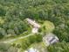 Aerial view of a sprawling home with a long driveway, set amidst lush greenery, mature trees, and a well-maintained yard at 2760 Hembree Ne Rd, Marietta, GA 30062