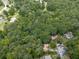 Aerial view of a wooded neighborhood showcasing homes nestled among lush trees and winding roads, offering privacy and natural beauty at 2760 Hembree Ne Rd, Marietta, GA 30062