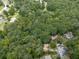 Aerial view of a wooded neighborhood showcasing homes nestled among lush trees and winding roads, offering privacy and natural beauty at 2760 Hembree Ne Rd, Marietta, GA 30062