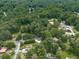 Aerial view showcases a home nestled in a lush, green, wooded neighborhood at 2760 Hembree Ne Rd, Marietta, GA 30062