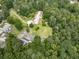 Aerial view of a charming home with mature landscaping, surrounded by lush greenery and neighboring houses in a serene setting at 2760 Hembree Ne Rd, Marietta, GA 30062