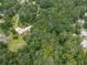 Aerial view showcasing a neighborhood with mature trees, lush green spaces, and winding roads, highlighting the area's natural beauty at 2760 Hembree Ne Rd, Marietta, GA 30062