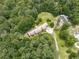 Stunning aerial view of a sprawling home nestled amongst mature trees, with a long driveway and lush green surroundings at 2760 Hembree Ne Rd, Marietta, GA 30062