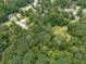 Lush wooded acreage containing a home. Close to roads and other neighborhood homesites, the home is set back from view at 2760 Hembree Ne Rd, Marietta, GA 30062