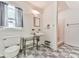 Cozy bathroom featuring classic tile flooring, a pedestal sink, and a shower stall, blending vintage charm with functionality at 2760 Hembree Ne Rd, Marietta, GA 30062