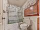 Cozy bathroom featuring patterned tiles, bathtub with shower, and classic window coverings at 2760 Hembree Ne Rd, Marietta, GA 30062