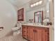Bright bathroom with wooden vanity, large mirror, and window providing natural light at 2760 Hembree Ne Rd, Marietta, GA 30062