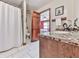 Well-lit bathroom featuring a shower/tub combo, modern fixtures, and tiled floors at 2760 Hembree Ne Rd, Marietta, GA 30062
