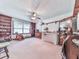 Inviting bedroom with built-in bookcases, ceiling fan, and a comfortable seating area at 2760 Hembree Ne Rd, Marietta, GA 30062