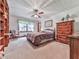 Comfortable bedroom featuring a ceiling fan, dresser, and window with natural light at 2760 Hembree Ne Rd, Marietta, GA 30062